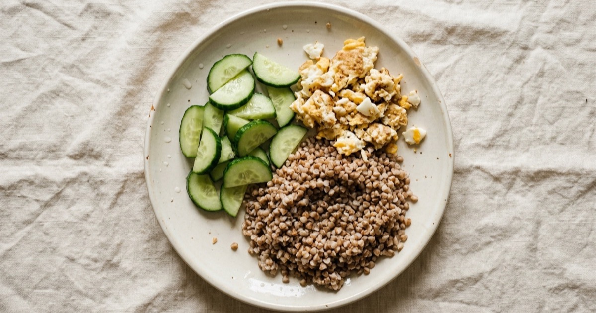 Buckwheat with eggs and cucumber — eggs, buckwheat, cucumber on a plate built around the Harvard Healthy Eating Plate