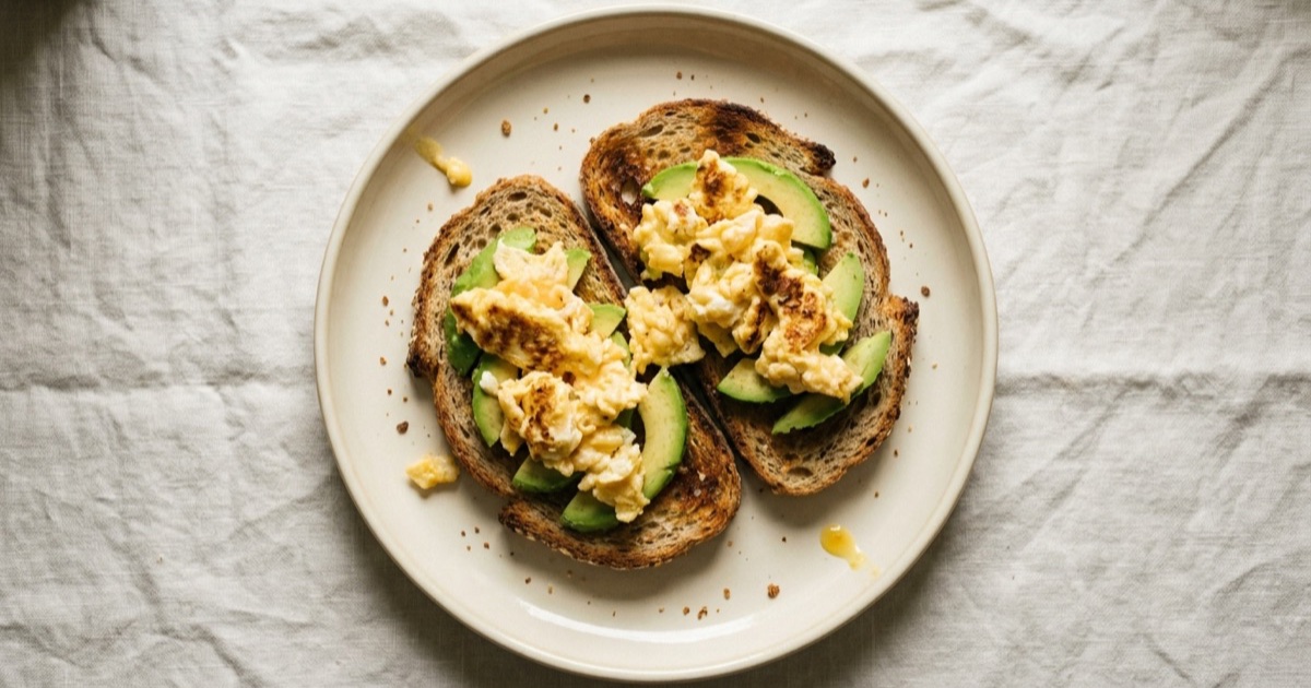 Open toasts with eggs β eggs, whole-grain bread, avocado on a plate built around the Harvard Healthy Eating Plate