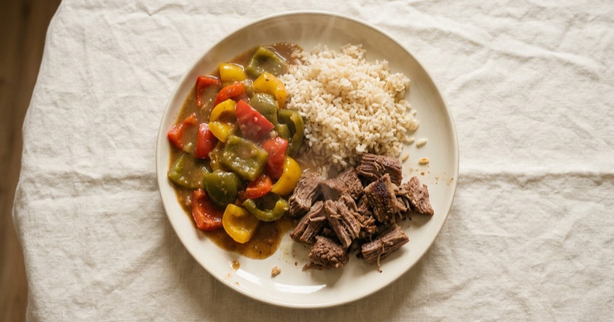Vegetable stew with bell pepper and beef — beef, rice, bell pepper on a plate built around the Harvard Healthy Eating Plate